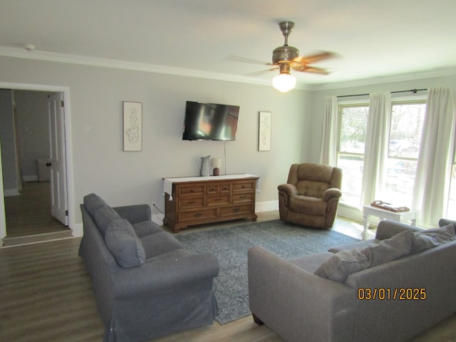 living room with ceiling fan, baseboards, crown molding, and wood finished floors