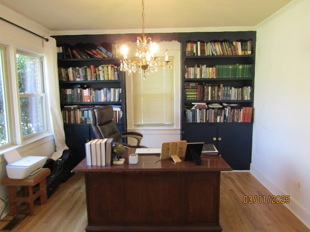 office area with baseboards, crown molding, an inviting chandelier, and wood finished floors