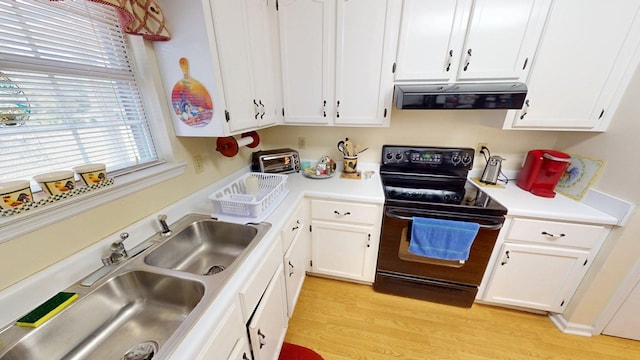 kitchen featuring white cabinets, black electric range, a sink, and range hood