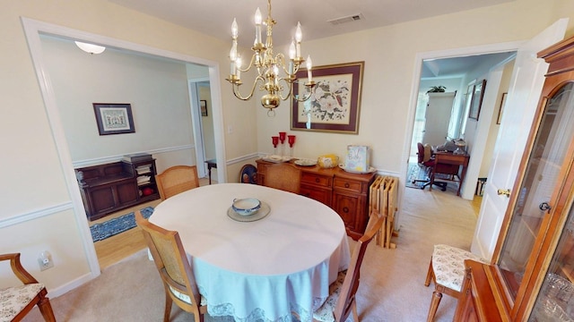 dining area featuring light colored carpet, a notable chandelier, and visible vents