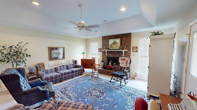 living area featuring ceiling fan, a wealth of natural light, and carpet