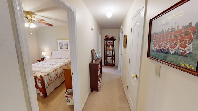 hall featuring light carpet