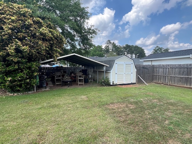 view of yard featuring a fenced backyard, a detached carport, an outbuilding, and a shed