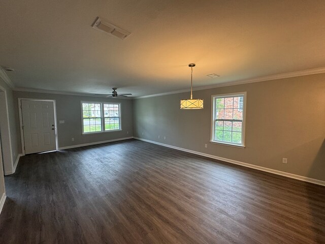 unfurnished room with ceiling fan, baseboards, and dark wood-type flooring