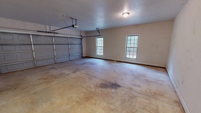 garage featuring baseboards and a garage door opener