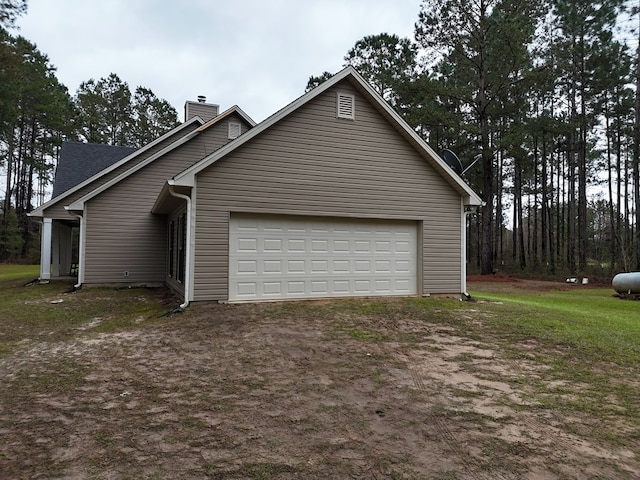 view of side of property with driveway and a chimney