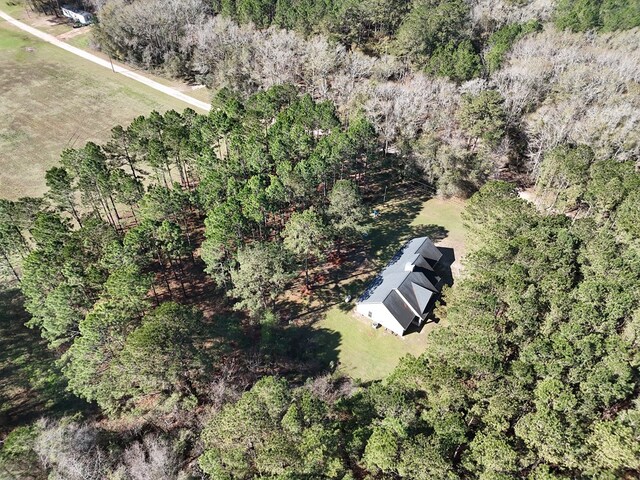 birds eye view of property featuring a view of trees