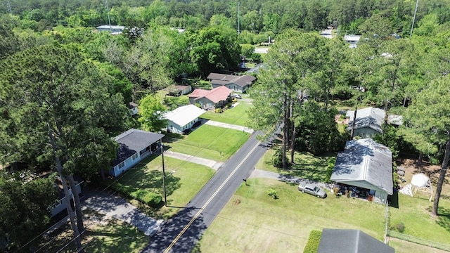 birds eye view of property featuring a wooded view