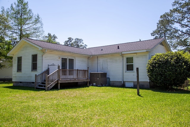 back of house with crawl space, a yard, a wooden deck, and central AC