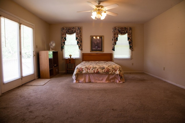 carpeted bedroom with access to outside, baseboards, multiple windows, and ceiling fan