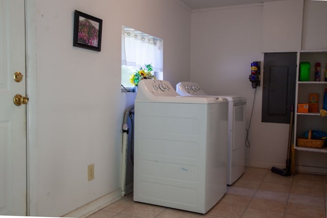 laundry room with baseboards, electric panel, light tile patterned flooring, laundry area, and washing machine and clothes dryer