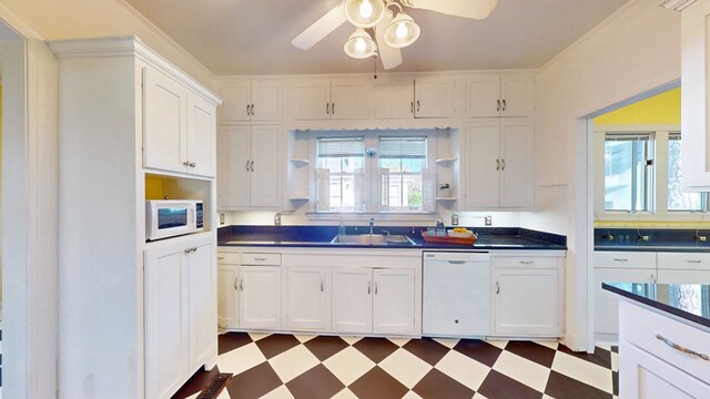 kitchen featuring white cabinetry, sink, ceiling fan, and white appliances