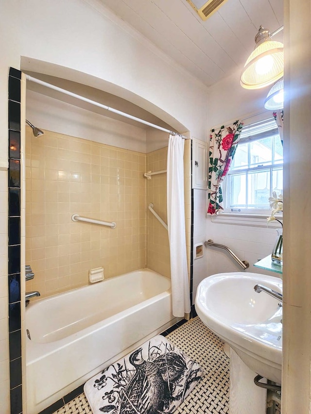 bathroom with tile patterned floors, sink, and shower / tub combo