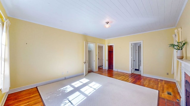 unfurnished bedroom with hardwood / wood-style floors and ornamental molding