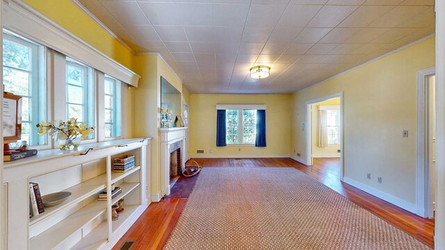 interior space with crown molding and hardwood / wood-style flooring