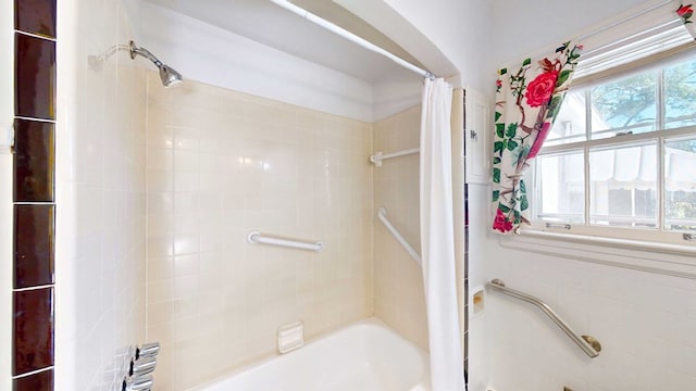 bathroom with shower / tub combo and a wealth of natural light