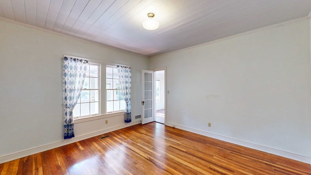 spare room featuring wood ceiling, wood-type flooring, and ornamental molding