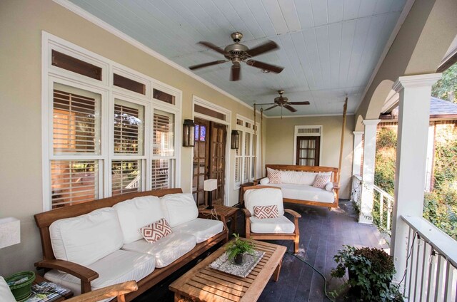 sunroom / solarium featuring wooden ceiling, ceiling fan, and ornate columns