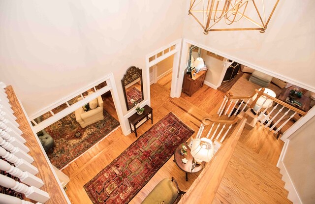 living room with wood-type flooring and a towering ceiling