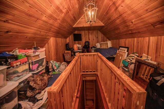 interior space featuring wooden ceiling, a chandelier, vaulted ceiling, and wood walls