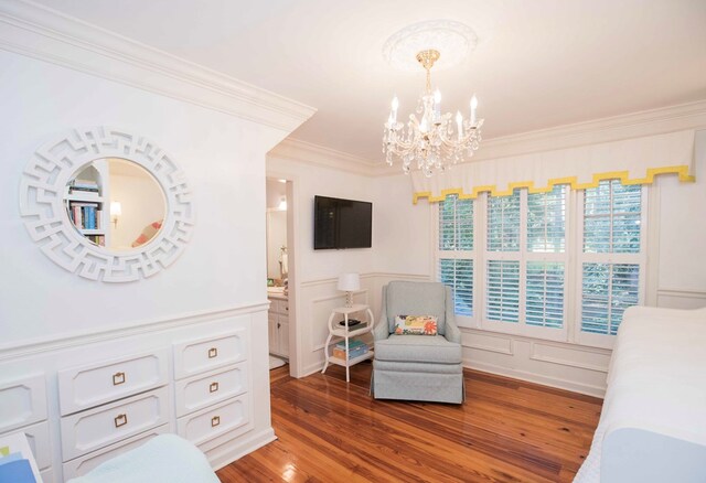 bedroom with dark hardwood / wood-style flooring, ornamental molding, and an inviting chandelier