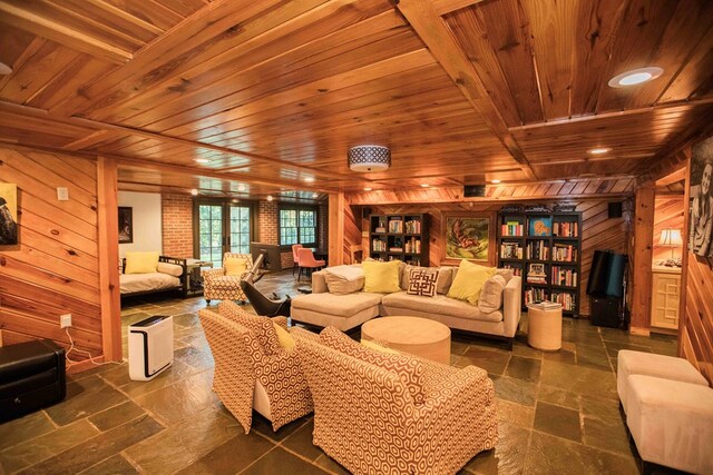 living room with wood ceiling and wooden walls