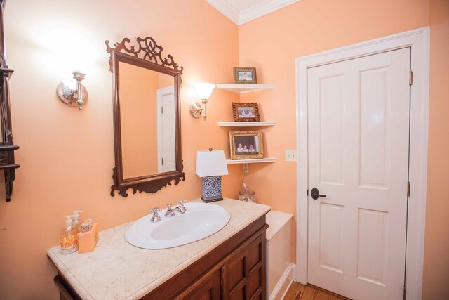 bathroom with ornamental molding and vanity