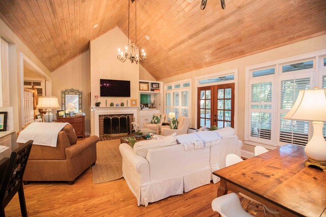 living room featuring french doors, a notable chandelier, wood ceiling, and light hardwood / wood-style floors