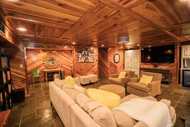 home theater featuring wood ceiling and wood walls