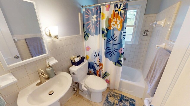 303 Glenwood Dr, Thomasville, GA 31792 - full bath featuring shower / tub combo, tile walls, a wainscoted wall, and tile patterned flooring