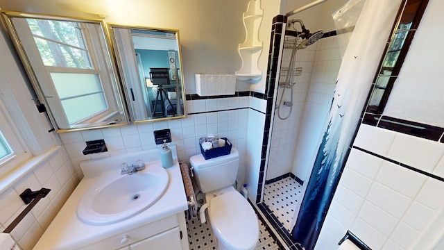 303 Glenwood Dr, Thomasville, GA 31792 - full bath with tile walls, healthy amount of natural light, a stall shower, vanity, and a wainscoted wall