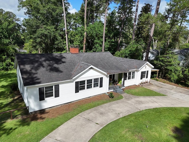 303 Glenwood Dr, Thomasville, GA 31792 - single story home with covered porch, a shingled roof, a chimney, driveway, and a front lawn