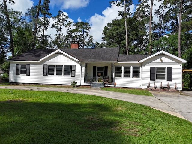 303 Glenwood Dr, Thomasville, GA 31792 - ranch-style house with covered porch, a chimney, a front lawn, a shingled roof, and driveway