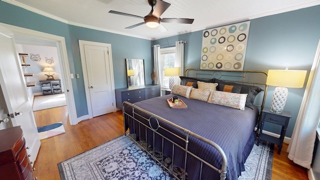 303 Glenwood Dr, Thomasville, GA 31792 - bedroom with wood finished floors, ornamental molding, and a ceiling fan