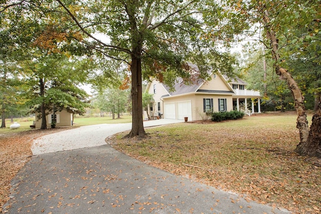 view of front of home featuring a garage and a front lawn