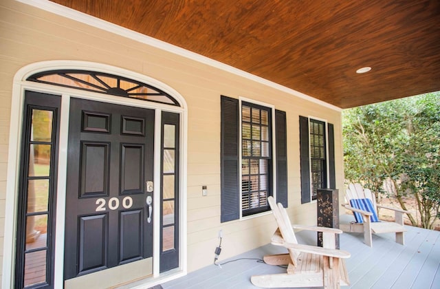 view of exterior entry with covered porch