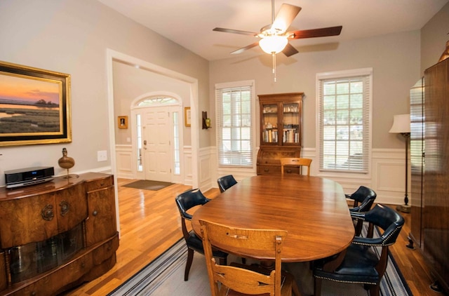 dining space with a wealth of natural light, ceiling fan, and light hardwood / wood-style flooring