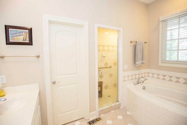 bathroom featuring tile patterned floors, independent shower and bath, and vanity