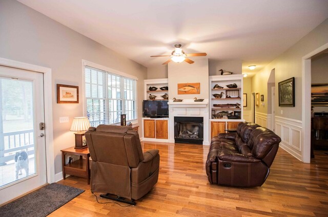 living room with ceiling fan and light hardwood / wood-style floors