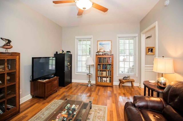 living room with hardwood / wood-style flooring and ceiling fan