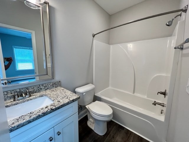 full bathroom with vanity, toilet, shower / bath combination, and hardwood / wood-style floors