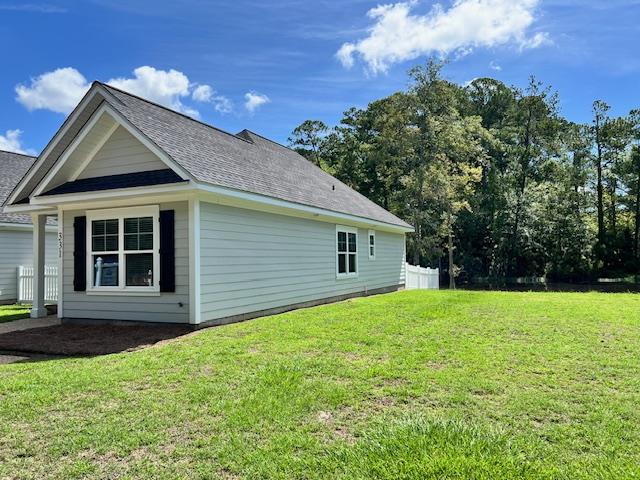 view of side of property with a yard