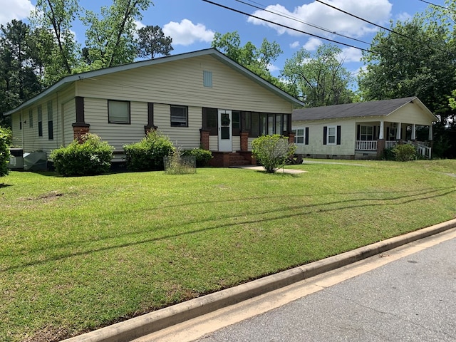 ranch-style house with a porch and a front yard