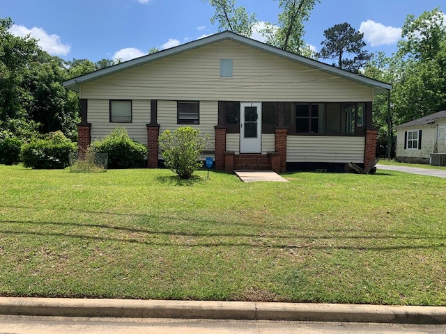 view of front of home featuring cooling unit and a front lawn