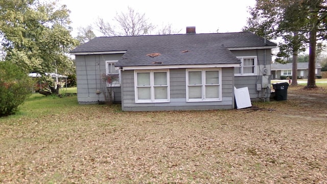 47 Morningside Dr, Camilla, GA 31730 - rear view of house featuring a shingled roof and a chimney