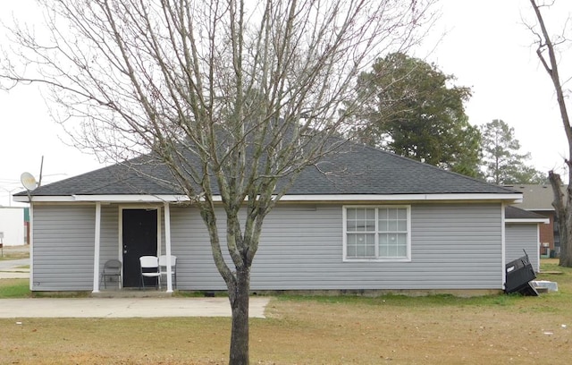 back of house with a lawn