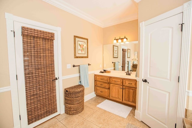 bathroom featuring crown molding, tile patterned floors, and vanity