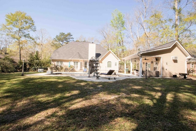 back of house with a lawn, ceiling fan, and a patio area