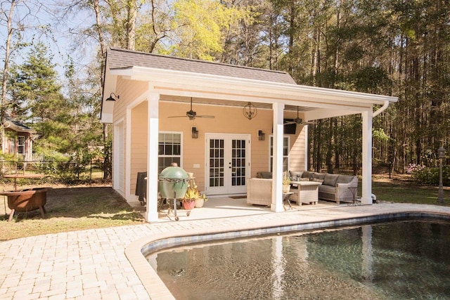 view of swimming pool with an outdoor hangout area, a patio, an outbuilding, grilling area, and french doors