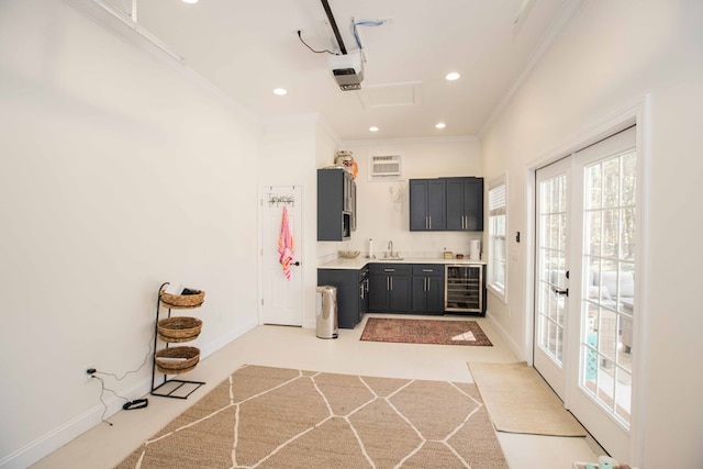 bathroom featuring wine cooler, crown molding, sink, and french doors